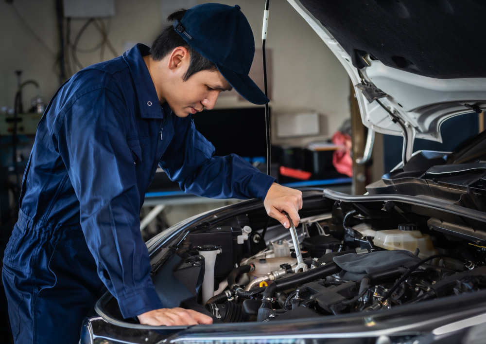 male mechanic using wrench repair engine car service